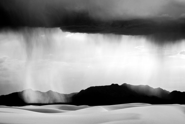 "Black & White Sand Storm" captures a breathtaking view of White Sands National Monument as a desert rain storm passes overhead. White Sands, New Mexico. Black and white, limited edition print by photographer Aranka Israni